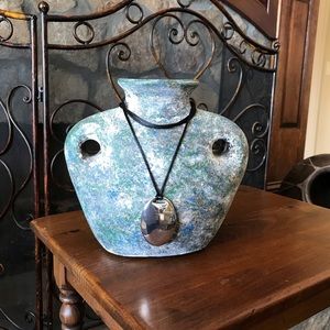 Adjustable black necklace with an oval silver pendent. Multi use.